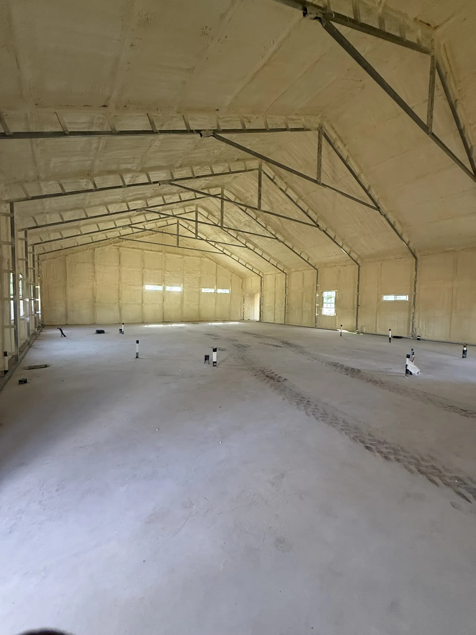 Finished spray foam insulation on the walls and roof of a large metal building