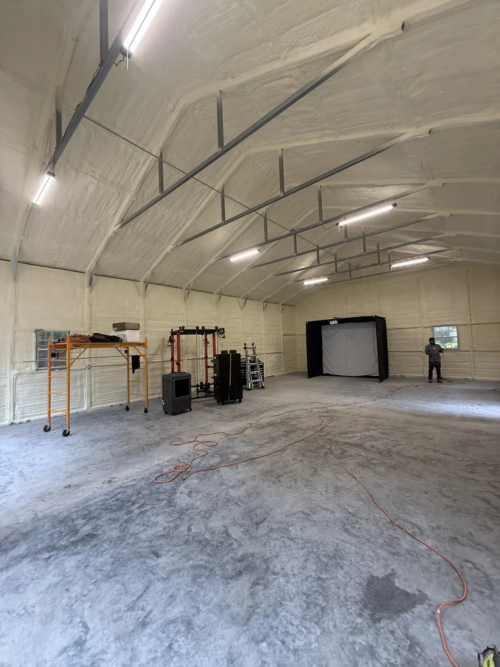Same metal building after closed-cell spray foam on walls and roof