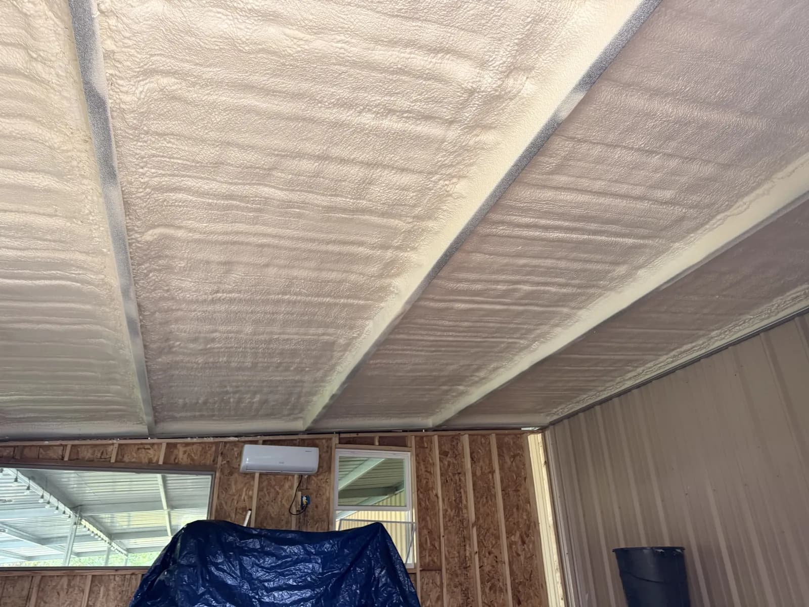 Spray foam sprayed on the underside of a shop roof